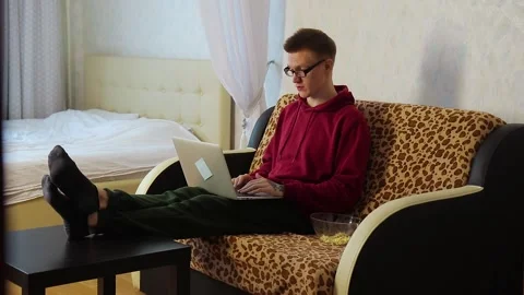 Young man on the couch video chatting with friends Video stock 150268340
