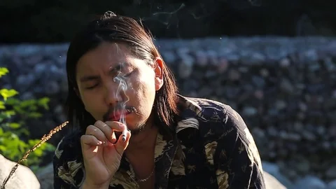 Young man coughing while smoking cigarette, slow motion Stock Footage 76009463