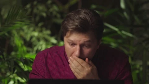 Young man coughs while sitting at the computer Stock Footage 149037267