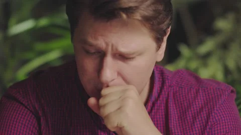 Young man coughs while sitting at the computer Stock Footage 150158527