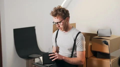 A young man is counting parcels in a notebook Video stock 149773715