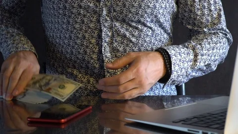 A young man counts dollars. Stock Footage 114380875