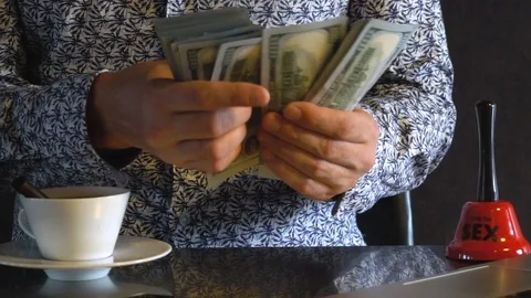 A young man counts dollars. Video stock 114381287
