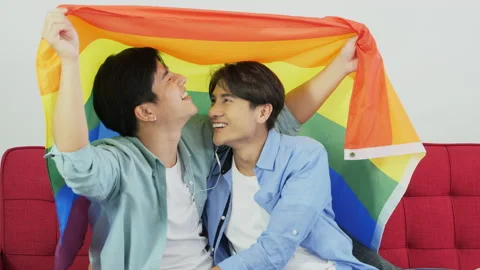 Young man covered himself with the flag of LGBT Gender diversity symbol. They 스톡 동영상 138311973