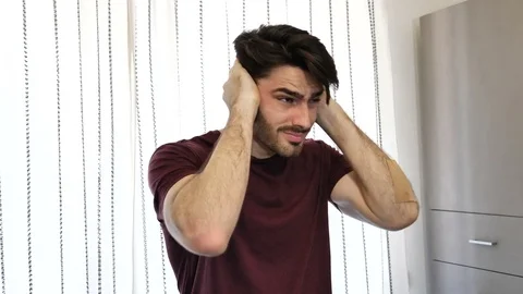 Young man covering his ears, too much noise Stock Footage 79925689