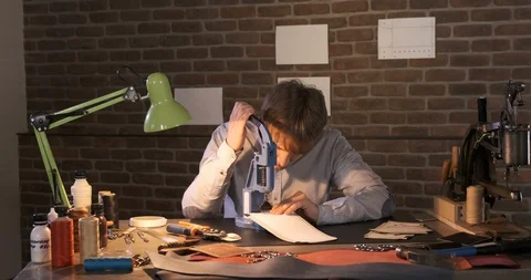 Young man create black leather product his home workshop Leather craft is hobby Stock Footage 129566605