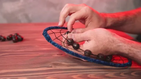 Young man creates dream catcher in workshop. Stock Footage 144792054