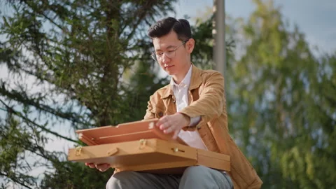 Young man creates landscape art. Man carefully sketches nature scenery using Stock Footage 329791043