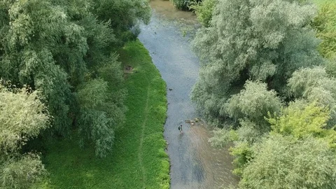 A young man crosses a river Stock Footage 112882850