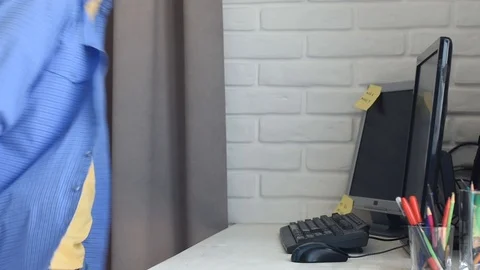 The young man crouched at a workplace with a computer and started work Stock Footage 126872613