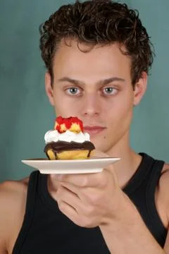 Young man with cupcake Stock Photos