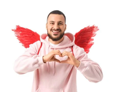Young man with Cupid's wings making heart gesture on white background. Valent Stock Photos