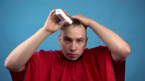 A young man cuts himself baldly. A man uses a hairdressing machine cuts his hair Stock Footage 136417789