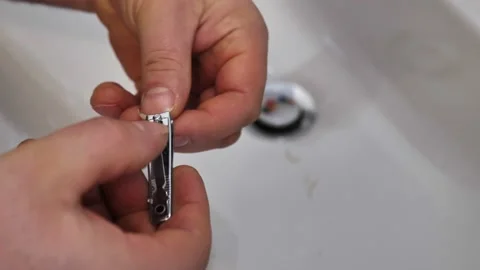 A young man cuts his nails over the sink. Video stock 149271124
