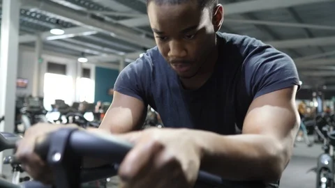 Young Man Cycles on Bicycle Machine at Gym 4K Stock Footage 98671885