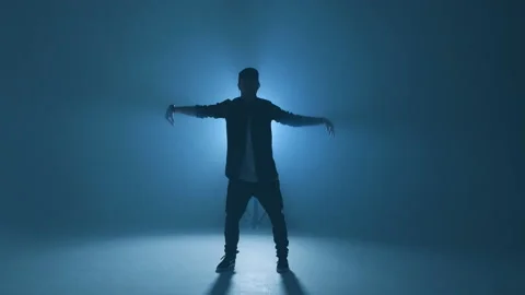Young man dancer dancing funky hip hop on isolated studio neon blue background Stock Footage 105185793
