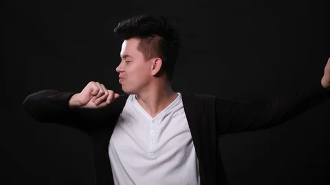 A Young Man Dancing Against a Black Background Stock Footage 87292583