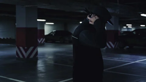 Young man dancing alone in an underground parking garage Видео 332539334