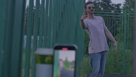 A young man is dancing and recording a TIKTOK Stock-Footage 156294926