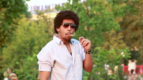 Young man dancing and smoking cigarette Stock Footage 51298842