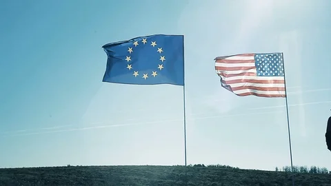 A young man dancing on the background of the EU flag and the flag of America. Stock Footage 96148919