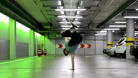 Young man dancing breakdance in the garage. Stock Footage 70556761