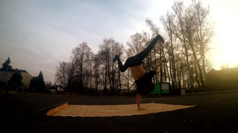 Young man dancing breakdance on the street at sunset Stock Footage 48683350