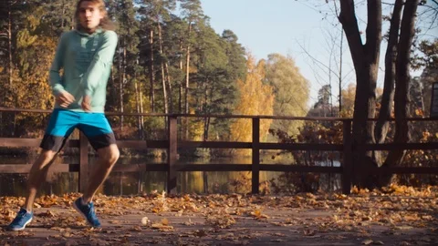 Young man dancing on the bridge Video stock 97313882