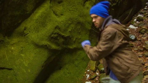 Young man dancing in the canyon Stock Footage 82567713