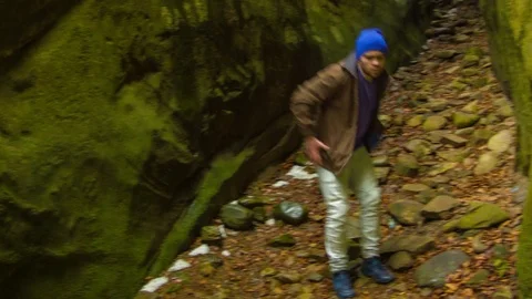 Young man dancing in the canyon Stock Footage 82572117