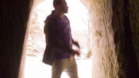 Young man dancing in the cave doorway 動画素材 82430661