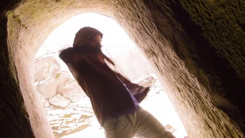 Young man dancing in the cave doorway Video stock 82453556