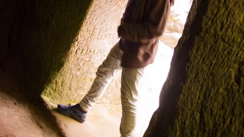 Young man dancing in the cave doorway 스톡 동영상 82455213