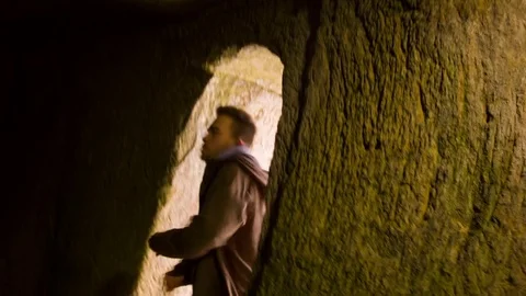 Young man dancing in the cave doorway Vídeo Stock 82455701