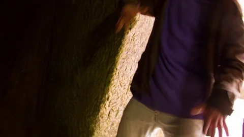 Young man dancing in the cave doorway Video stock 82456104