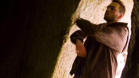 Young man dancing in the cave doorway Video stock 82456549