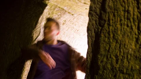 Young man dancing in the cave doorway 스톡 동영상 82456987