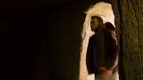 Young man dancing in the cave doorway 스톡 동영상 82458030