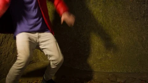 Young man dancing in the cave. Видео 82463148