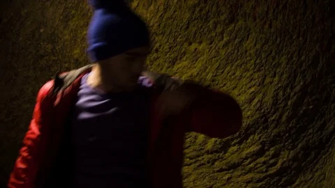 Young man dancing in the cave. Stock Footage 82468665