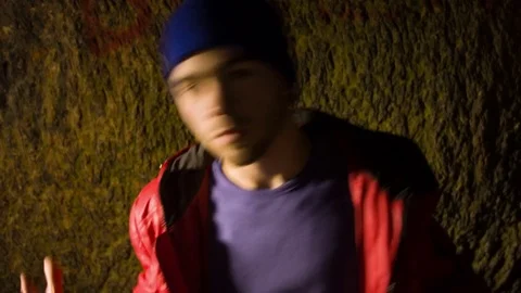 Young man dancing in the cave. 스톡 동영상 82481946