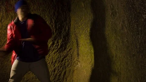 Young man dancing in the cave. 動画素材 82485041