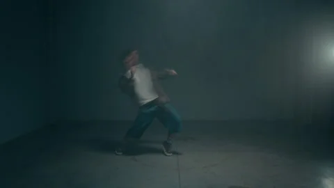 Young Man Dancing Dynamically under Strobing Lights with Motion Blur Stock Footage 335680740