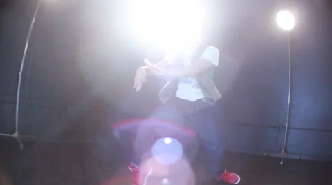Young Man dancing on the floor with low angle flare Stock Footage 22831152