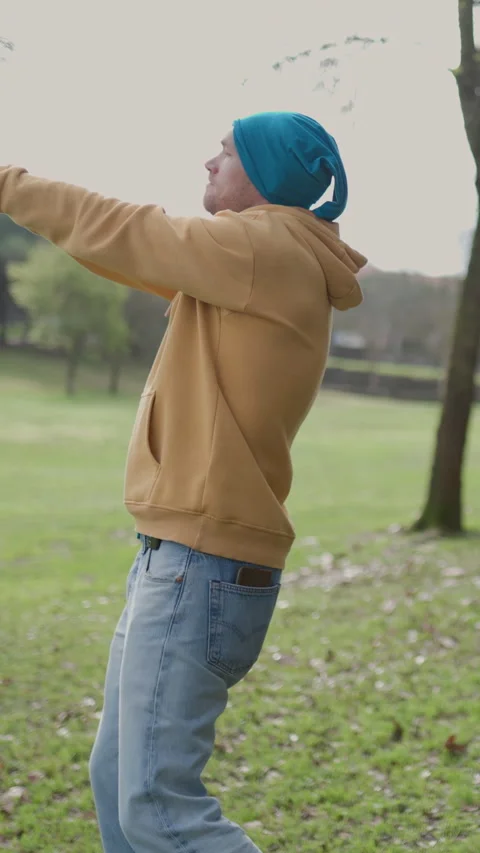 Young man dancing freestyle in a public park Stock Footage 327233575