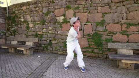 Young man dancing freestyle in urban setting Stock Footage 303335384