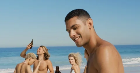 Young man dancing with friends at the beach 4k Stock Footage 113382858