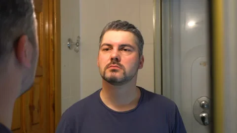 Young man dancing in front of a mirror 4K Video stock 127401664