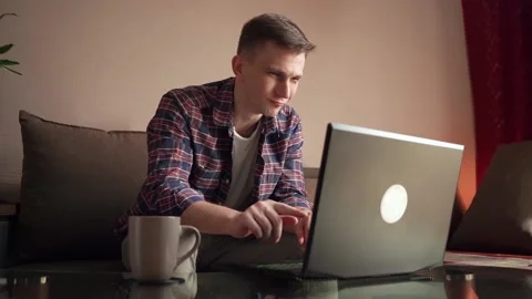Young man is dancing with happy face in front of laptop screen. Stock Footage 207780201