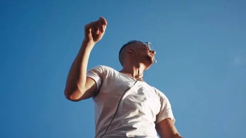Young man dancing with headphones Stock Footage 95021064